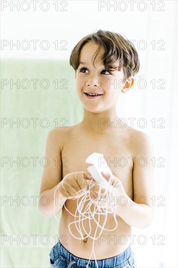 Boy (6-7) with dental floss