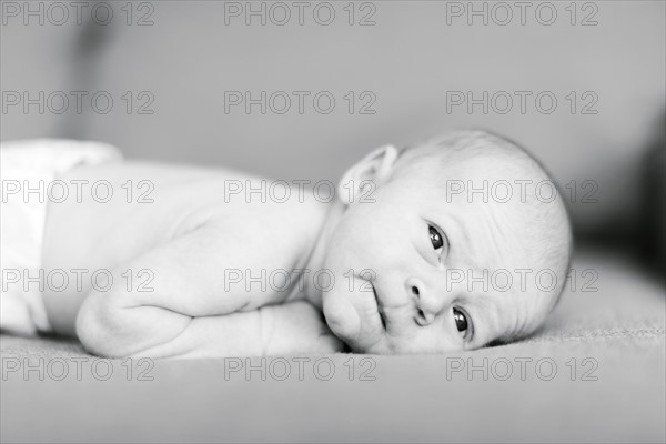 Portrait of one day Baby boy (0-1 months) lying on sofa