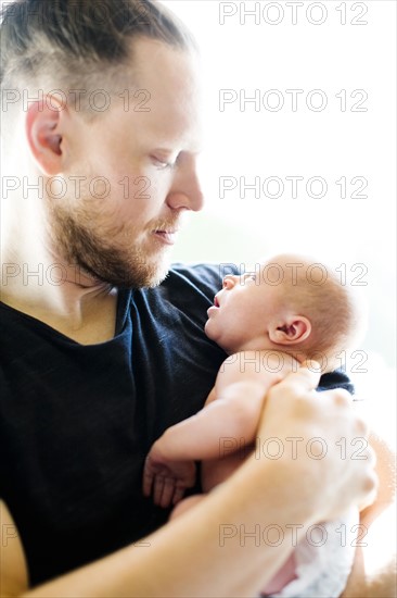 Portrait of man holding his on day son (0-1 months)