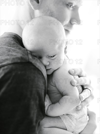 Portrait one day baby boy (0-1 months) being hold by his father