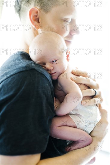 Portrait of man holding his on day son (0-1 months)
