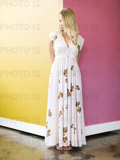 Young woman wearing long dress standing on corner