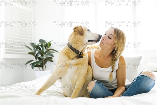 Portrait of blond woman with golden retriever