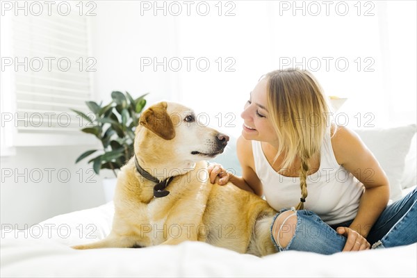 Portrait of blond woman with golden retriever