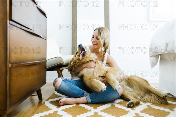 Portrait of blond woman with golden retriever