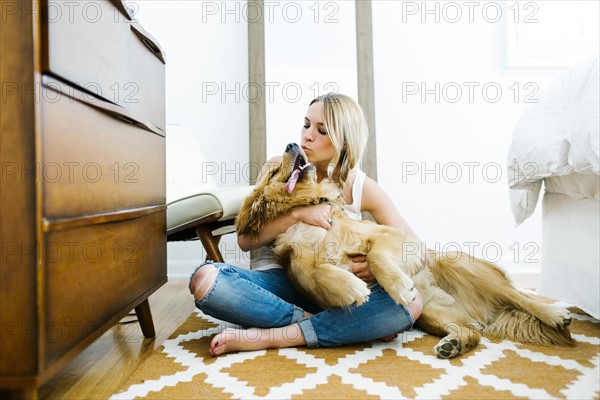 Portrait of blond woman with golden retriever