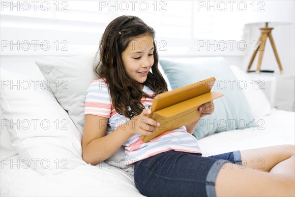 Portrait of girl (10-11 ) using digital tablet