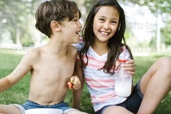 Portrait of sister ( 10-11 ) and brother (6-7 ) on picnic