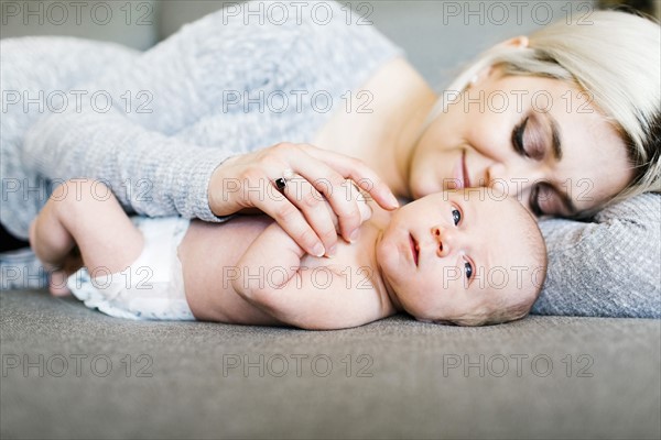 Portrait of newborn boy ( 0-1 months ) with mother