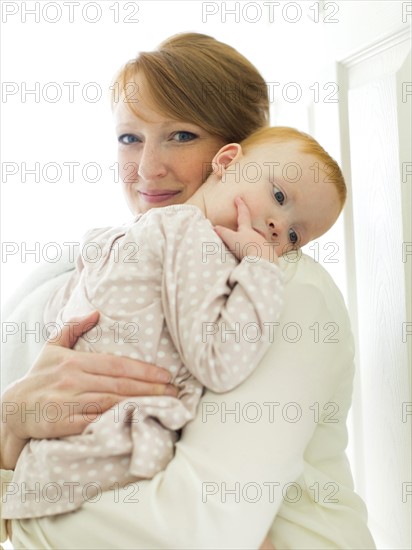 Portrait of mother embracing daughter ( 12-17 months )