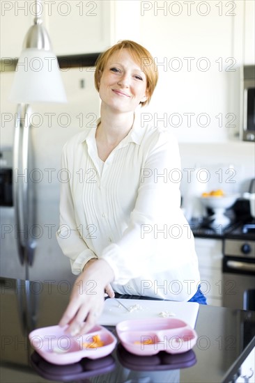 Portrait of smiling woman preparing lunch