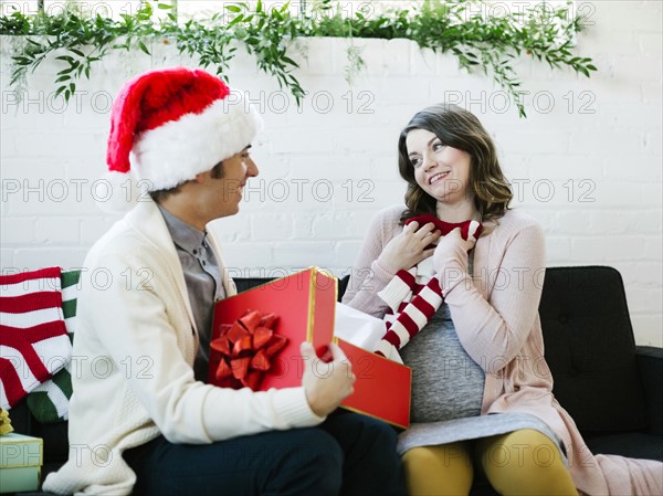 Pregnant woman receiving christmas present