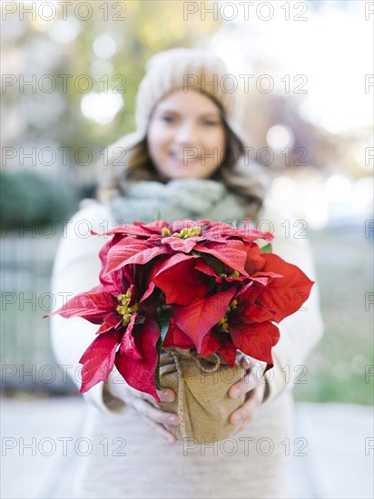 Woman holding poinsettia