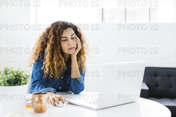 Woman using laptop at table