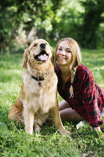 Portrait of woman with dog in nature