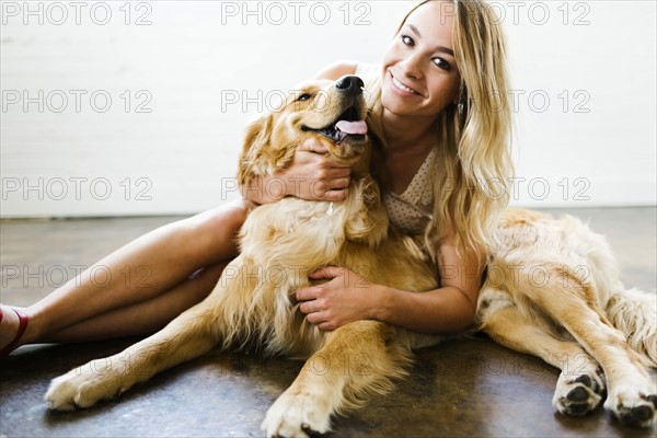 Woman cuddling dog