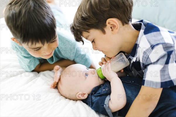 Portrait of brothers with newborn