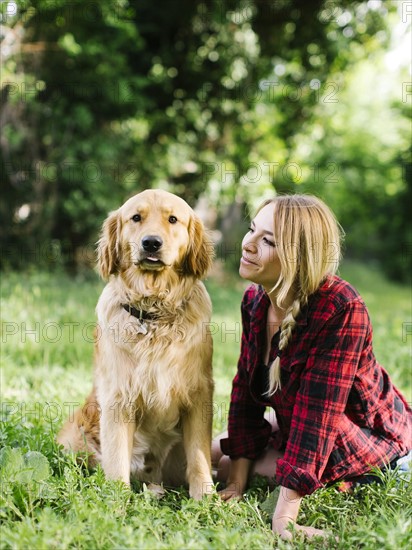 Portrait of woman with dog in nature