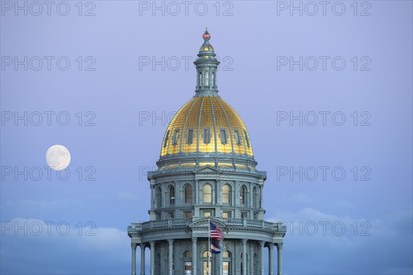 USA, Colorado, Denver, Full moon rising next to State Capitol dome