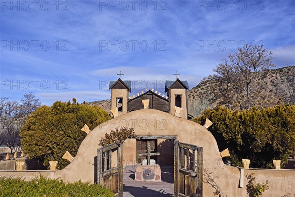 USA, New Mexico, Chimayo, El Santuario de Chimayo among trees and mountains