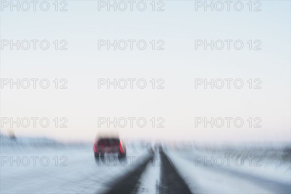 USA, New Mexico, Car on snowy highway