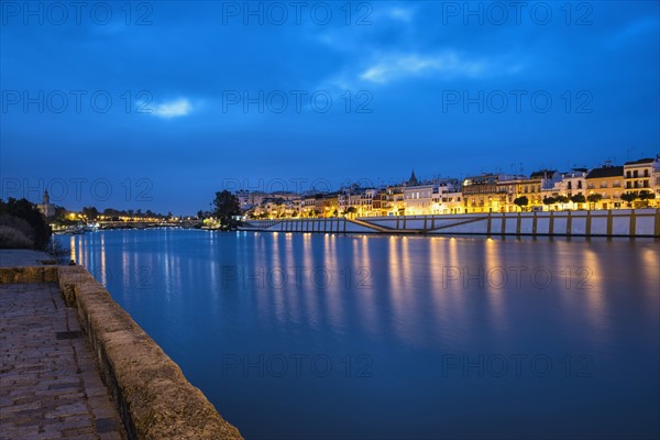 Spain, Seville, Triana, Guadalquivir river at dusk