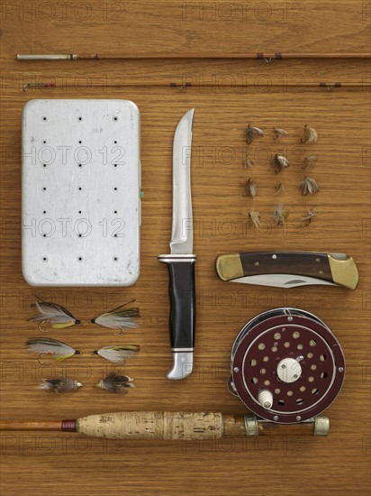 Studio shot of flyfishing equipment on wooden table