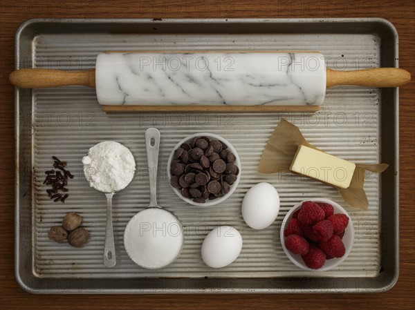 Studio shot of baking sheet with rolling pin and fresh ingredients
