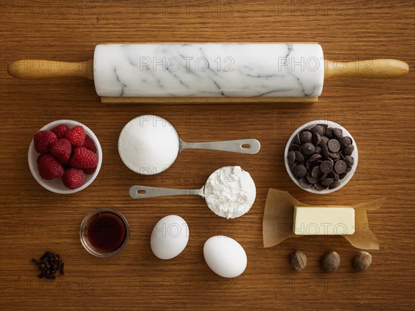 Studio shot of wooden table with rolling pin and fresh ingredients