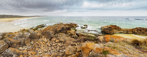 Australia, New South Wales, Bournda National Park, Rocky seashore with overcast sky