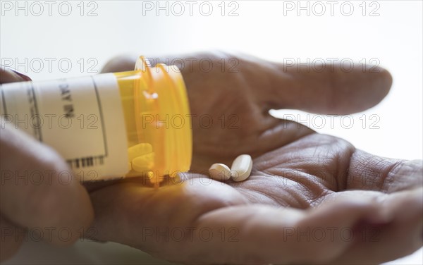 Female hand holding pill bottle