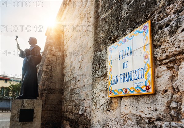 Cuba, Havana, Plaza De San Francisco, Tile sign next to statue of Francis of Assisi