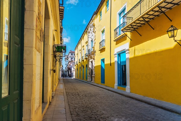 Cuba, Havana, Street with yellow houses