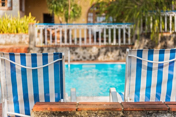 Cuba, Havana, Deck chairs by swimming pool