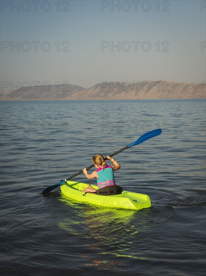 Girl (4-5) kayaking on lake