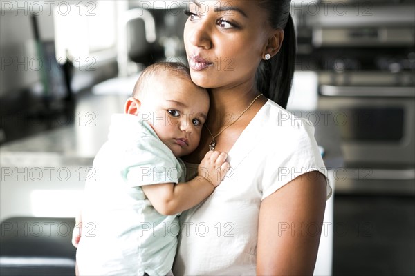 Portrait of mother holding baby boy (2-5 months)