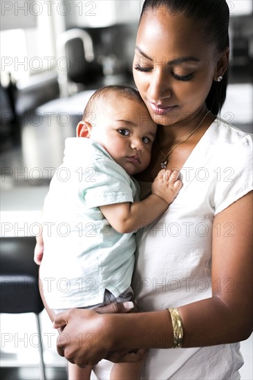 Portrait of mother holding baby boy (2-5 months)