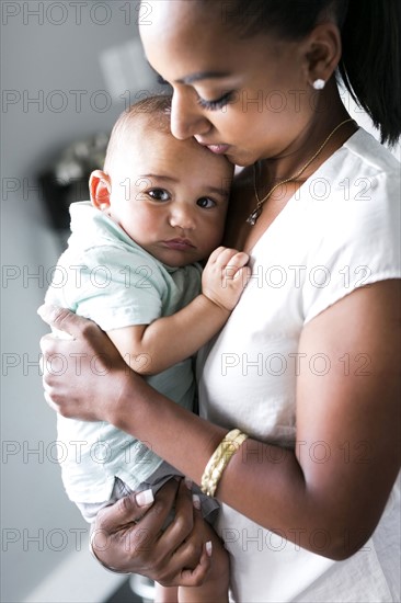 Portrait of mother holding baby boy (2-5 months)