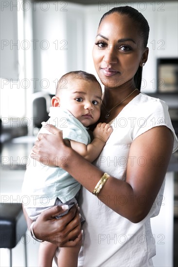 Portrait of mother holding baby boy (2-5 months)