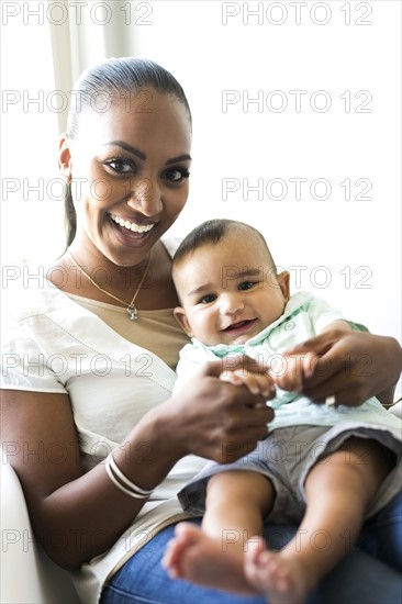 Portrait of mother holding baby boy (2-5 months)