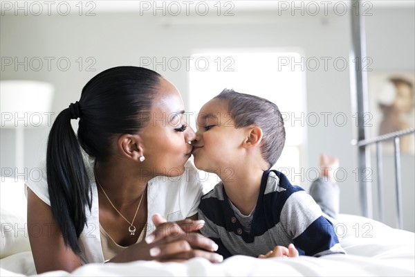 Mother kissing son (2-3)