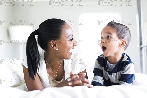 Mother and son (2-3) laughing