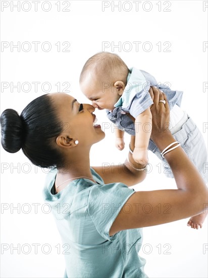 Mother holding baby boy (2-5 months)