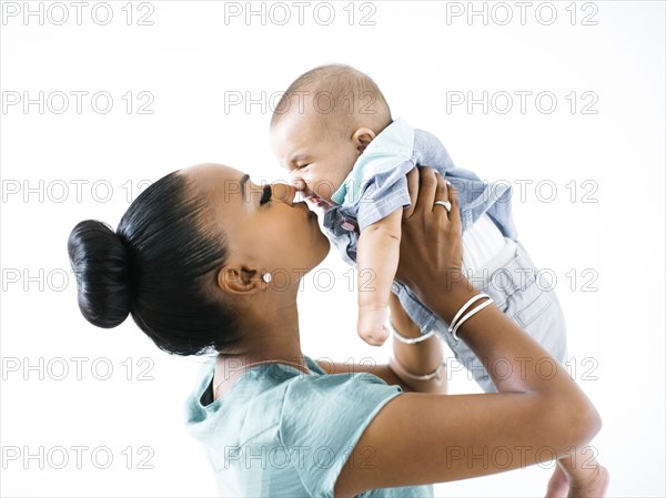 Mother holding baby boy (2-5 months)