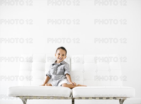 Portrait of boy (2-3) sitting on white sofa