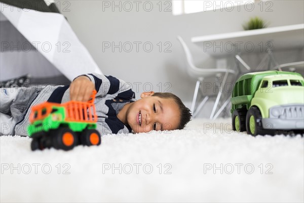 Boy (2-3) playing with toys in room