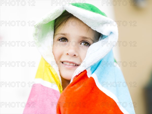 Portrait of smiling girl (4-5) in colorful towel