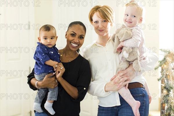 Portrait of mothers holding children (2-5 months, 12-17months)