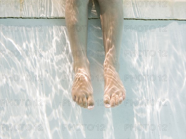 Legs of girl (4-5) underwater