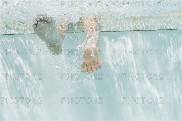 Legs of girl (4-5) underwater